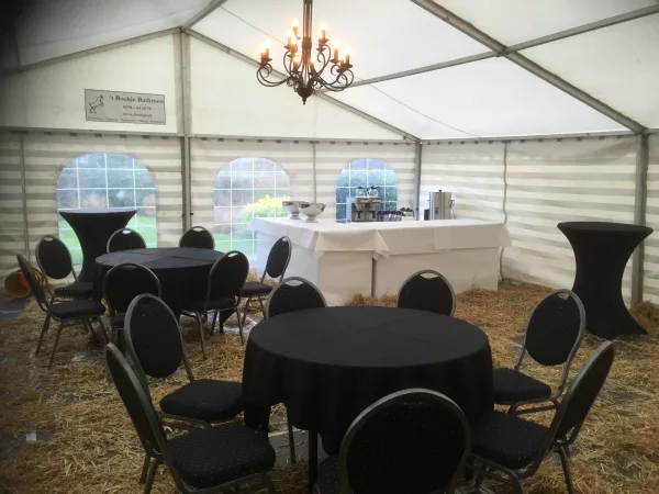 Tent opgezet voor een uitvaartbijeenkomst, met stoelen op rijen