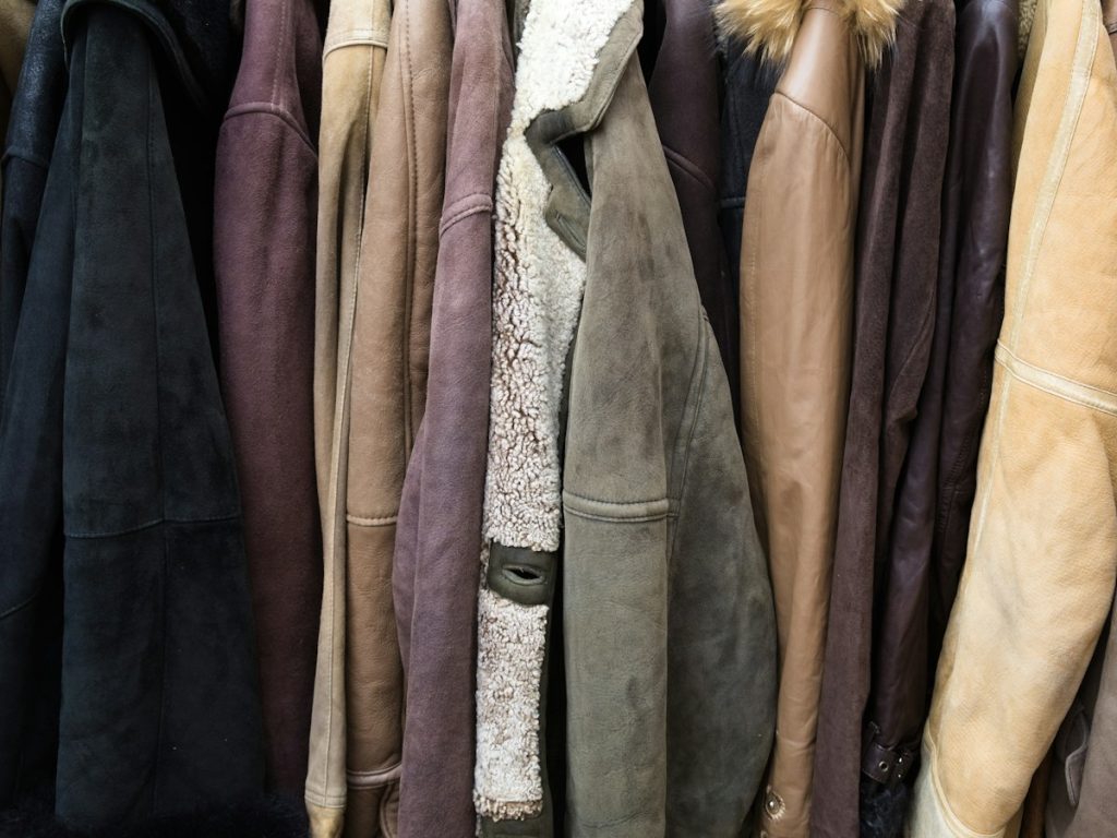 Leather and suede jackets side by side on a rail